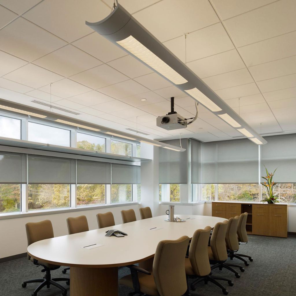 Office boardroom with table, chairs and wall-to-wall windows with Lutron window shades.